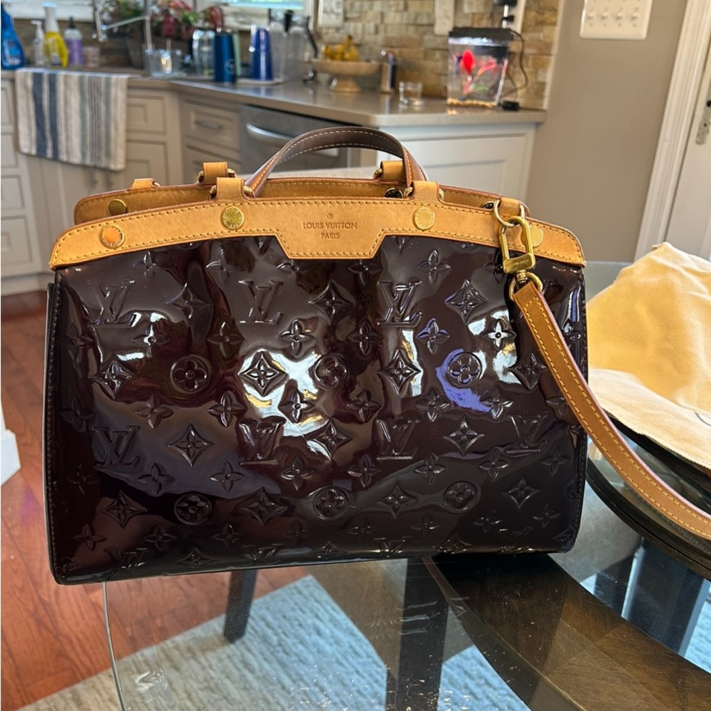 LV Monogram Vernier bag. Dark cranberry patent leather. Looks black sometimes.